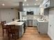 Modern kitchen with gray shaker cabinets, stainless steel appliances, and a large island at 407 Parson Brown Way, Longwood, FL 32750