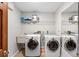 Bright laundry room, washer, dryer, utility sink, and ample storage at 43 Dahlia Dr, Debary, FL 32713