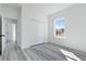 Bedroom with grey vinyl flooring, double closet, and window at 4774 Sw 152Nd Ln, Ocala, FL 34473