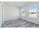 Bedroom with grey vinyl flooring and two large windows at 4774 Sw 152Nd Ln, Ocala, FL 34473