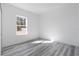 Bright bedroom with grey vinyl flooring and large window at 4774 Sw 152Nd Ln, Ocala, FL 34473