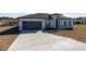 Newly constructed home with gray roof and driveway at 4774 Sw 152Nd Ln, Ocala, FL 34473