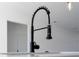 Close-up of a modern black gooseneck kitchen faucet at 4774 Sw 152Nd Ln, Ocala, FL 34473