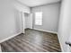 Well-lit bedroom with wood-look floors and closet at 5998 Sw 154Th Street Rd, Ocala, FL 34473