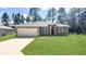 New construction home with attached garage and grassy lawn at 5998 Sw 154Th Street Rd, Ocala, FL 34473