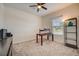 Bright bedroom with window, desk, and ceiling fan at 6324 Chirpine Ln, Saint Cloud, FL 34771