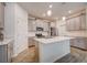 Modern kitchen with gray cabinets, stainless steel appliances, and an island at 6324 Chirpine Ln, Saint Cloud, FL 34771