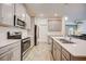 Modern kitchen with gray cabinets and stainless steel appliances at 6324 Chirpine Ln, Saint Cloud, FL 34771