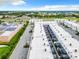 Aerial view showing community of townhouses with parking and surrounding landscape at 653 Trikomo Dr, Davenport, FL 33896