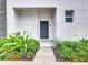 Townhouse entrance with landscaping at 653 Trikomo Dr, Davenport, FL 33896