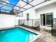 Enclosed private pool with patio and lounge chairs at 653 Trikomo Dr, Davenport, FL 33896