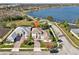 Aerial view of a two-story house near a lake, showcasing its location and neighborhood at 7202 Chelsea Harbour Dr, Orlando, FL 32829