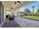 Relaxing backyard patio with covered seating area, pavers, and lush landscaping at 7202 Chelsea Harbour Dr, Orlando, FL 32829