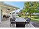 Outdoor dining area with large table and chairs on a covered patio at 7202 Chelsea Harbour Dr, Orlando, FL 32829