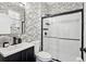 Stylish bathroom with black and white subway tile and patterned wallpaper at 7202 Chelsea Harbour Dr, Orlando, FL 32829