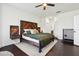 Main bedroom with wood-look headboard, dark green bedding, and ceiling fan at 7202 Chelsea Harbour Dr, Orlando, FL 32829