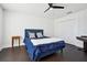 Blue bedroom with dark hardwood floors and a ceiling fan at 7202 Chelsea Harbour Dr, Orlando, FL 32829