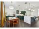 Kitchen dining area with mid-century modern table and chairs, and mustard yellow curtains at 7202 Chelsea Harbour Dr, Orlando, FL 32829