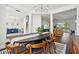 Open concept dining room with mid-century style furniture and view of the living room at 7202 Chelsea Harbour Dr, Orlando, FL 32829