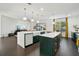 Spacious kitchen with double island, white quartz countertops, dark green cabinetry, and gold hardware at 7202 Chelsea Harbour Dr, Orlando, FL 32829