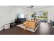 Living room with leather sectional sofa and dark brown wood floors at 7202 Chelsea Harbour Dr, Orlando, FL 32829