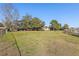 Large grassy backyard with a view of the lake and surrounding trees at 754 E Wildmere Ave, Longwood, FL 32750