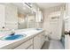 Bathroom with dual sinks, white vanity, and updated fixtures at 754 E Wildmere Ave, Longwood, FL 32750