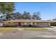 House exterior featuring a red door and stone facade at 754 E Wildmere Ave, Longwood, FL 32750