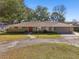 Single story home with stone accents and a circular driveway at 754 E Wildmere Ave, Longwood, FL 32750