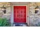 Red double front doors with stonework at 754 E Wildmere Ave, Longwood, FL 32750