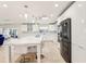 Modern white kitchen with large island and stainless steel appliances at 754 E Wildmere Ave, Longwood, FL 32750