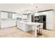 Modern white kitchen with large island, stainless steel appliances, and tiled floors at 754 E Wildmere Ave, Longwood, FL 32750