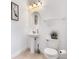 Clean and bright bathroom with pedestal sink and toilet at 7697 Fairfax Dr, Kissimmee, FL 34747