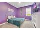 Purple bedroom with a gold bed frame and teal blanket at 7697 Fairfax Dr, Kissimmee, FL 34747