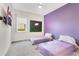 Bedroom with two twin beds and purple accents at 7697 Fairfax Dr, Kissimmee, FL 34747