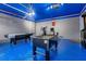 Finished garage with foosball table, air hockey, and exercise equipment at 7697 Fairfax Dr, Kissimmee, FL 34747