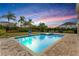 Inviting lighted pool and spa at sunset at 7697 Fairfax Dr, Kissimmee, FL 34747