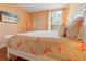 Bedroom with floral bedding and window at 8836 Dunes Ct # 307, Kissimmee, FL 34747