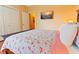 Charming bedroom with floral bedding and a flat-screen TV at 8836 Dunes Ct # 307, Kissimmee, FL 34747