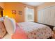 Bright bedroom with floral bedding and ample closet space at 8836 Dunes Ct # 307, Kissimmee, FL 34747