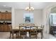 Dining room with wooden table and chairs, view of kitchen at 8882 Candy Palm Rd, Kissimmee, FL 34747