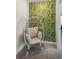 Cozy reading nook with egg chair and leafy wallpaper at 8882 Candy Palm Rd, Kissimmee, FL 34747