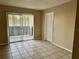 Bright living room with tile floors and sliding glass door at 950 Lake Destiny Rd # E, Altamonte Springs, FL 32714