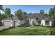 Single-story home with gray roof, attached garage, and landscaped lawn at Lot 35 Yellowleaf Circle, Orlando, FL 32820