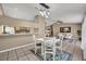 Bright dining area with kitchen pass-through and modern light fixture at 1004 Chance Cv, Oviedo, FL 32765