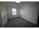 Simple bedroom with gray carpet and a window at 1053 Waterfall Blvd, Davenport, FL 33837