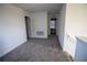 Upstairs hallway with gray carpet and access to bedrooms at 1053 Waterfall Blvd, Davenport, FL 33837