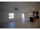 Spacious living room with tile flooring and access to the kitchen at 1053 Waterfall Blvd, Davenport, FL 33837