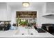 Kitchen features white cabinets, double sink, and modern appliances at 122 Magnolia Dr, Winter Haven, FL 33881