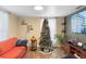 Living room with hardwood floors, a sofa, and a large TV at 122 Magnolia Dr, Winter Haven, FL 33881